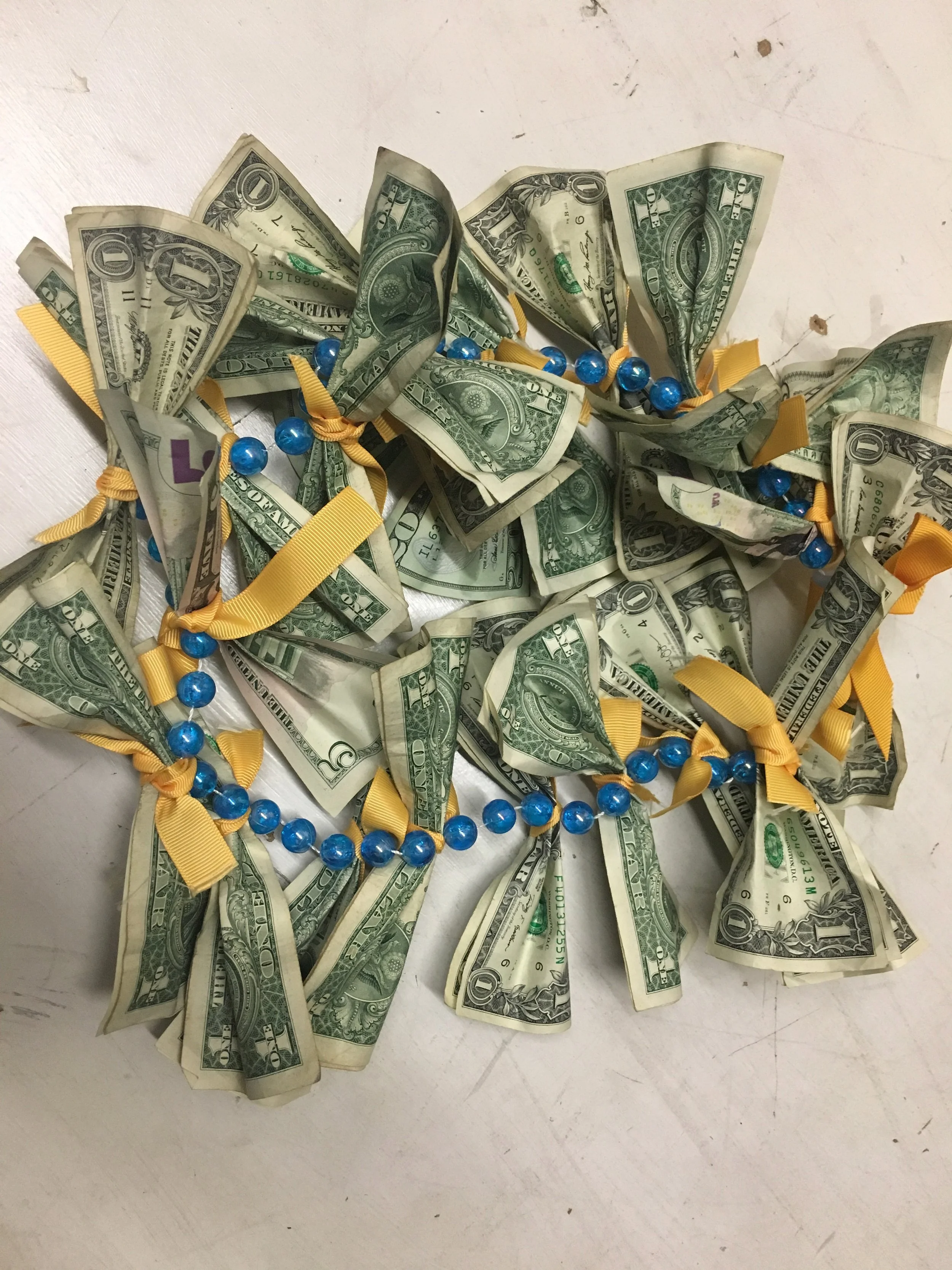 I couldn't find a plastic lei in time so I made one using a beaded necklace and ribbon in his favorite Dolphins' colors for our really good friend in Florida. I also couldn't fit single dollar bills so you'll notice larger denominations in the mix.