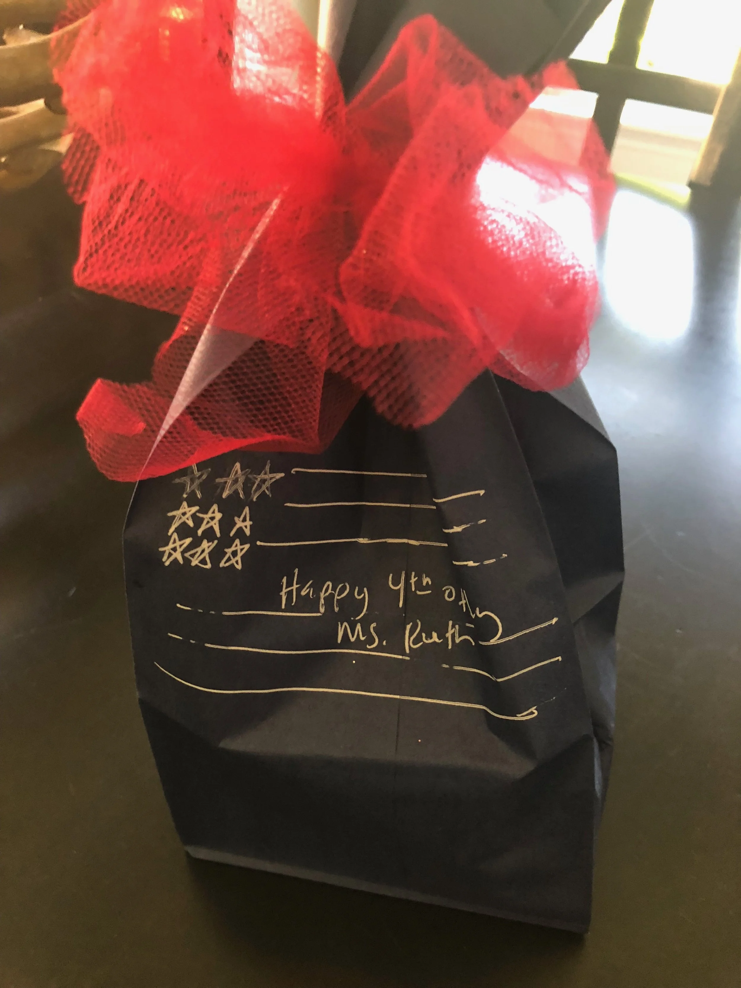 To give the crystal to our piano teacher, I wrapped it in white tissue, used a blue paper lunch bag and wrote a note with a white pen. I tied the bag with a strip of red tulle. 