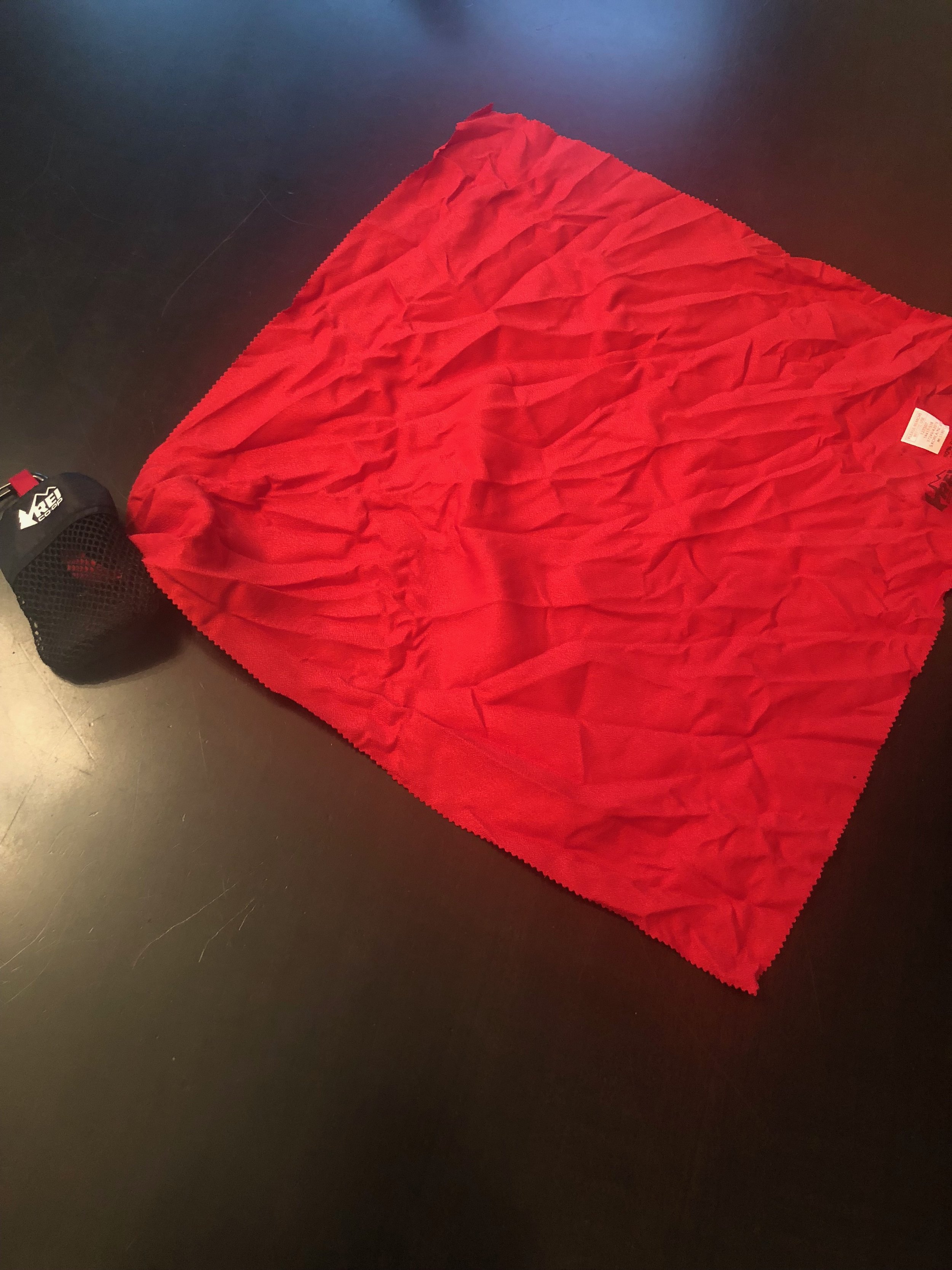 This towel was also included in the goody bag. Once the towel is tucked into the mesh bag, it can be hooked onto a back pack. Handy!