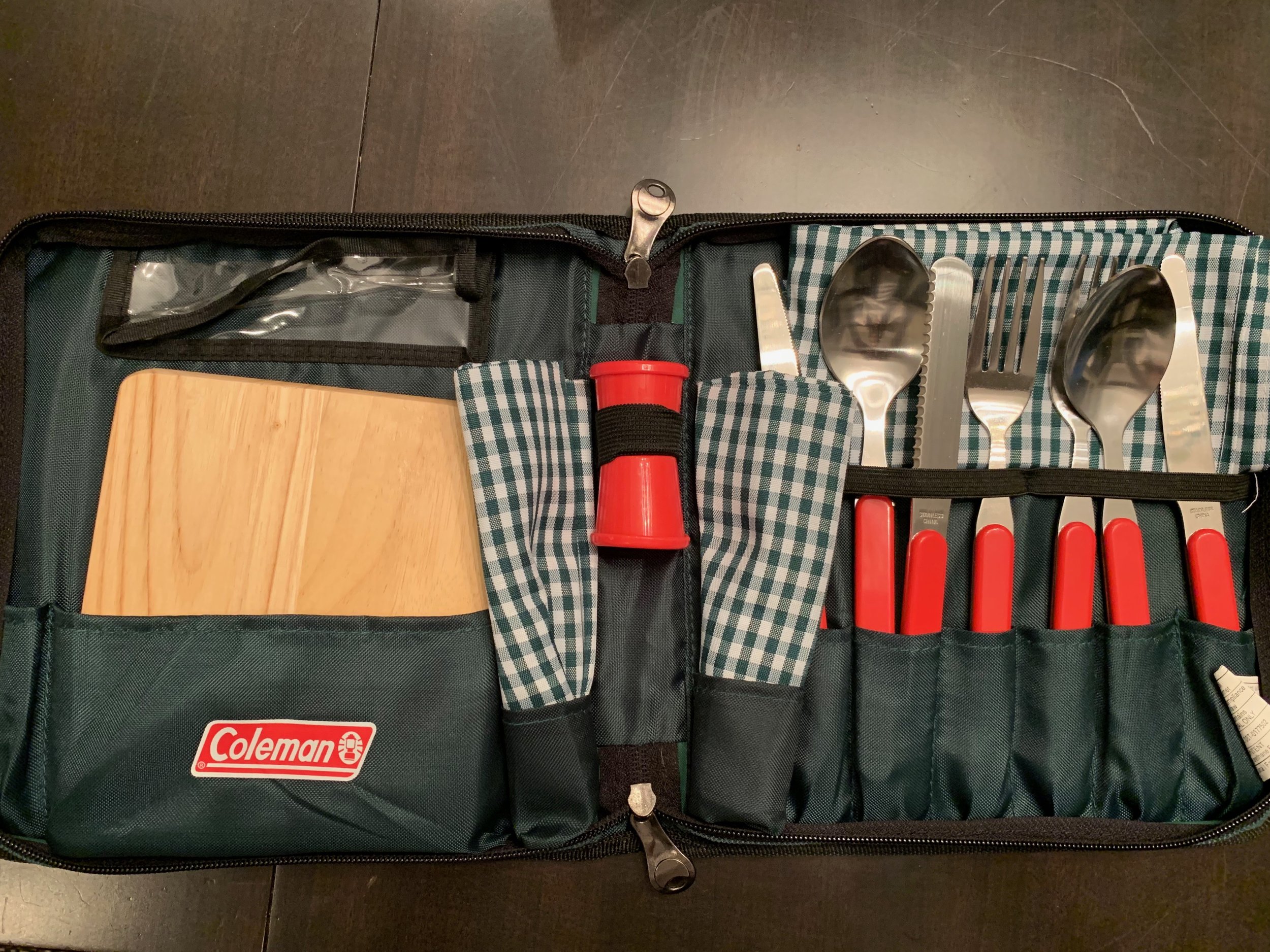 This kit has all we really need to cover the most basic tasks. Chopping board, two napkins, salt/pepper containers, two sets of flatware and serrated knife. This was an anniversary present from a lovely couple; both have since passed away. I think of them often when we use it.