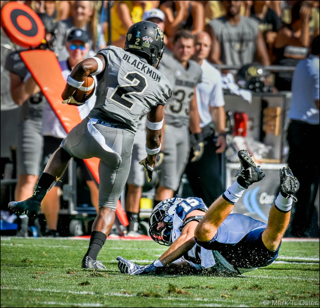 CU punt returner Ronnie Blackmon (#2) slips a tackle attempt by UNH linebacker Michael Balsamo (#15) on a 20-yard punt return early in the second quarter.