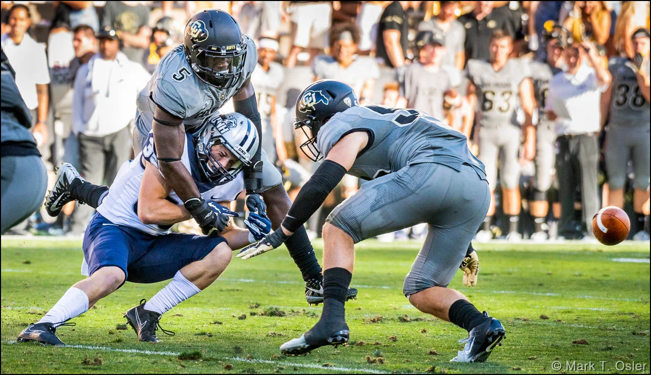 UNH wide receiver Neil O’Connor (#82) is unable to pull in a pass under pressure from CU linebackers Davion Taylor (#5) and Nate Landman (#53) early in the third quarter.
