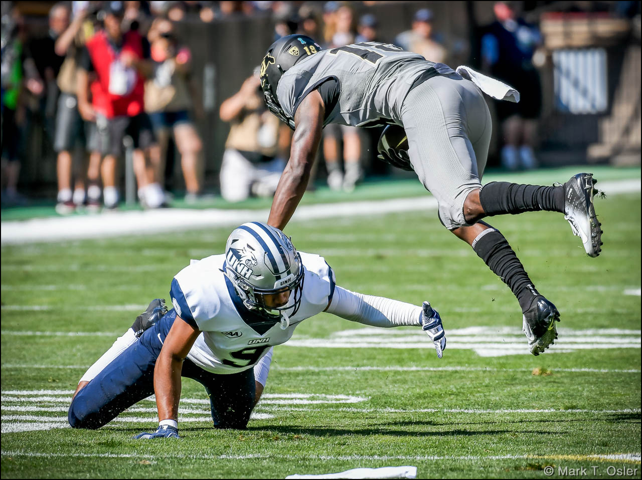 UNH cornerback Isiah Perkins (#9) takes down CU wide receiver Tony Brown (#18) for a 2-yard gain during the first quarter.