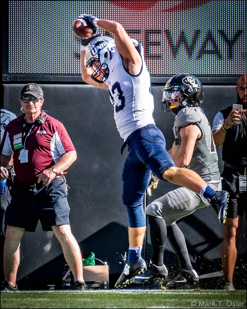UNH safety Evan Horn (#33) makes sure to get a foot in bounds after intercepting a pass from CU quarterback Steven Montez (not shown) intended for CU wide receiver Jay MacIntyre (#14) in the second quarter.