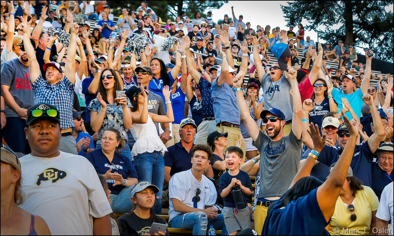 The UNH fan section at CU’s Folsom Field celebrates a 71-yard touchdown strike from UNH quarterback Christian Lupoli to Neil O’Connor in the third quarter, narrowing the score to 38-14, following the extra point.