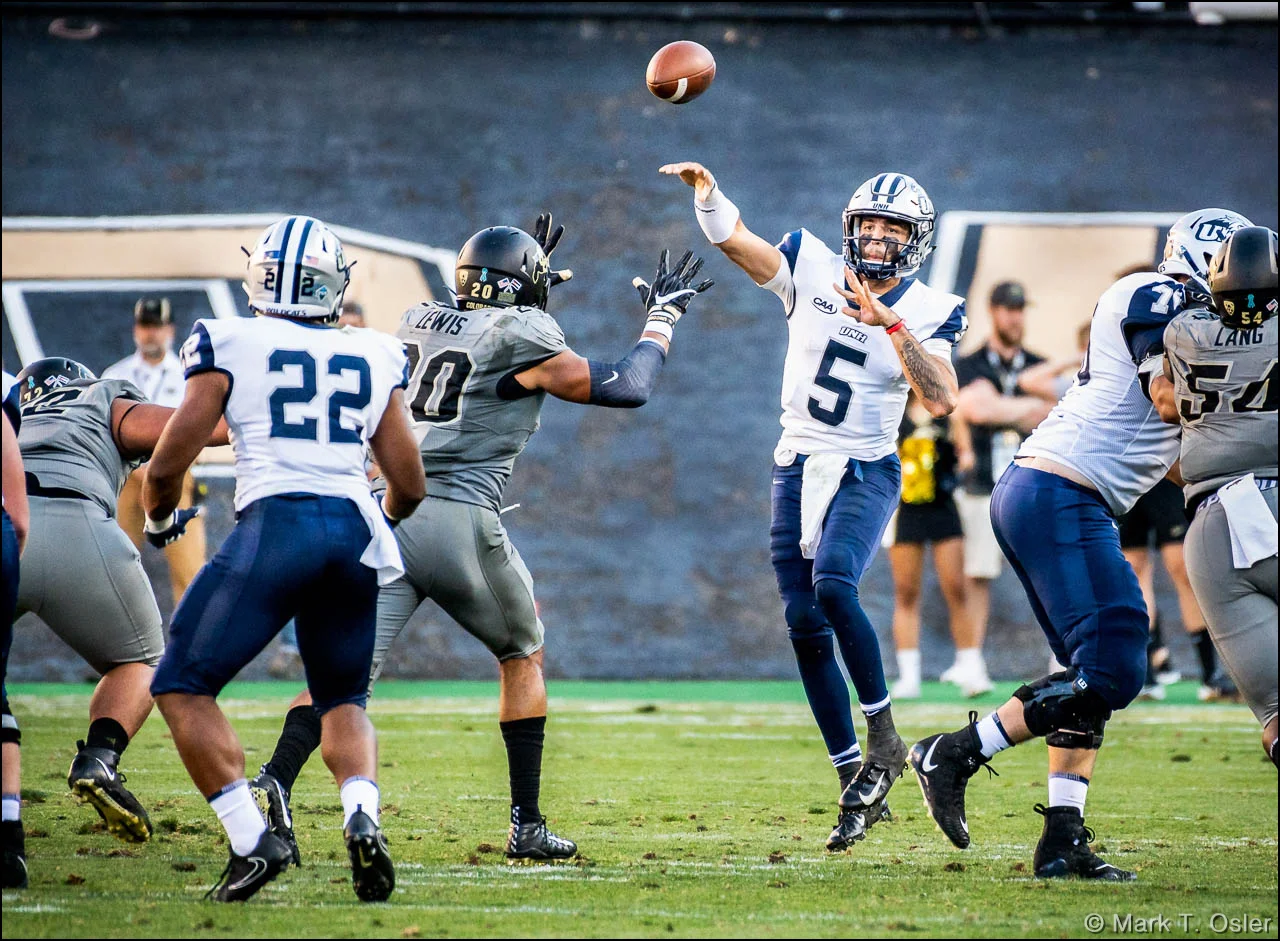 UNH quarterback Christian Lupoli (#5) completes a pass to running back Evan Gray (#22) early in the fourth quarter.