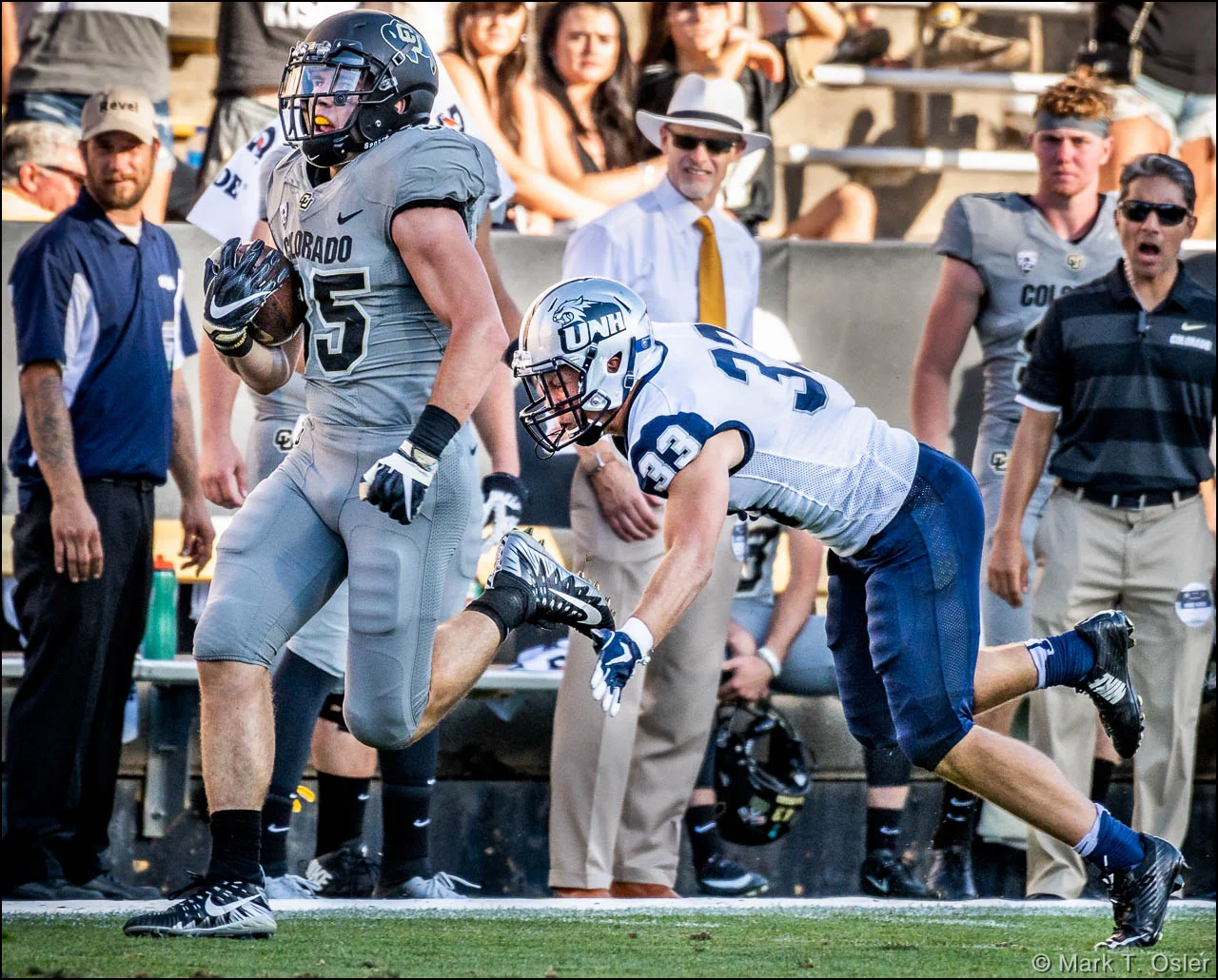 UNH safety Evan Horn (#33) dives to get a hand on the left foot of CU tailback Beau Bisharat (#35) and prevent a CU touchdown midway thru the third quarter. Bisharat gained 47 yards on the play.