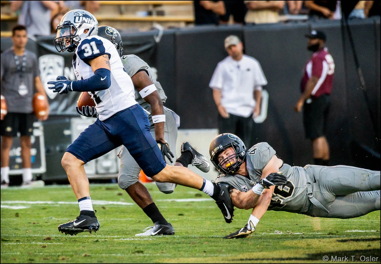 CU defensive back Chase Newman (#46) makes an unsuccessful attempt to stop UNH wide receiver Nick Lubischer (#31) on a 37-yard pass play to CU’s 32 yard line with 1:05 remaining in the game. The Wildcats only made it to CU's 22 yard line before time ran out.