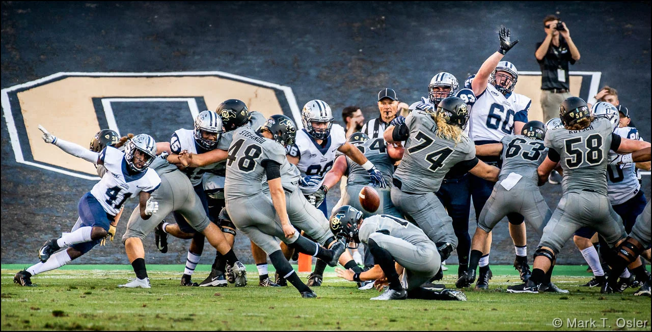 UNH defends against a CU extra point attempt by kicker James Stefanou (#48). Stefanou’s successful conversion was the final point of the game, putting CU ahead 45-14.