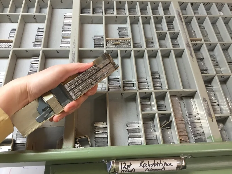 "Composing" the metal type for a broadside featuring a poem by Stan Galloway called " Winter Garden ."