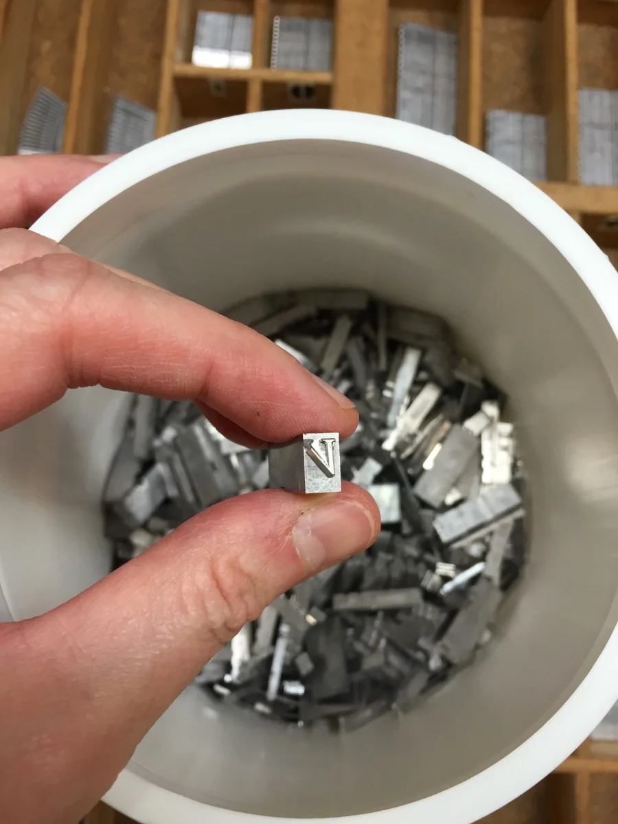 The St Brigid Press hell box, into which we pitch metal letters that are broken, scratched, dented, or otherwise rendered unprintable. Grateful acknowledgement goes to the Shop Dog, Mira, for generously donating an empty biscuit tub for the task.