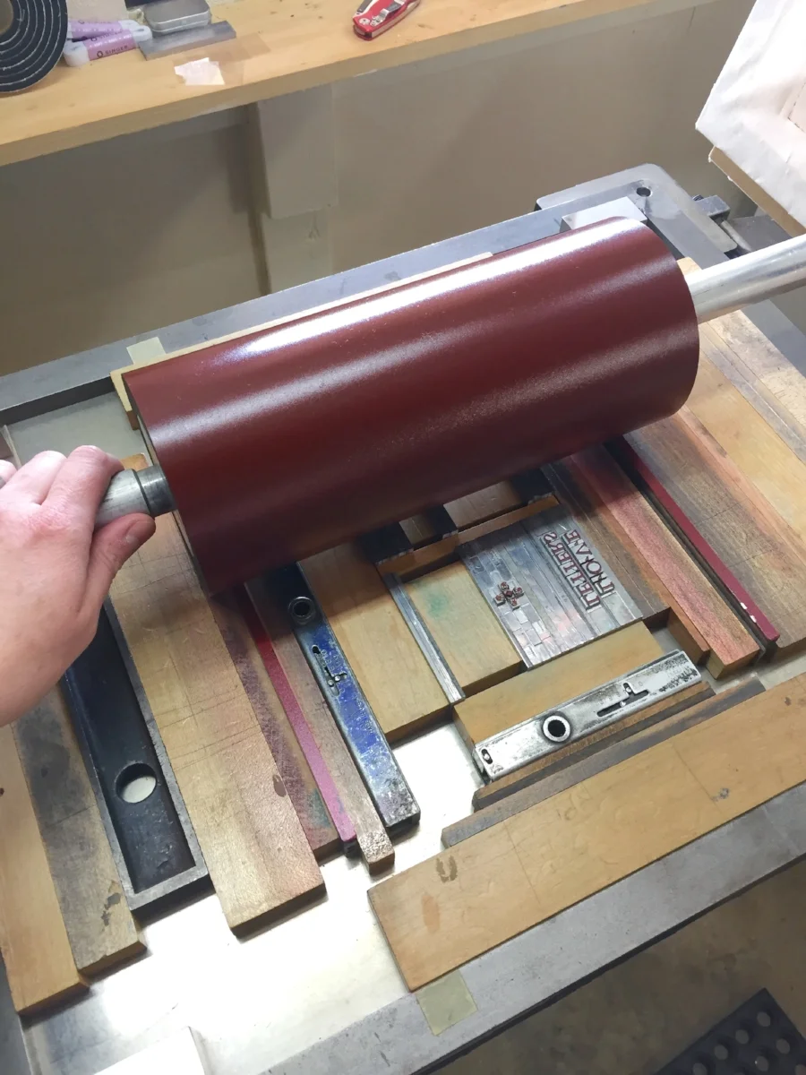  Rolling the red ink onto the type... 