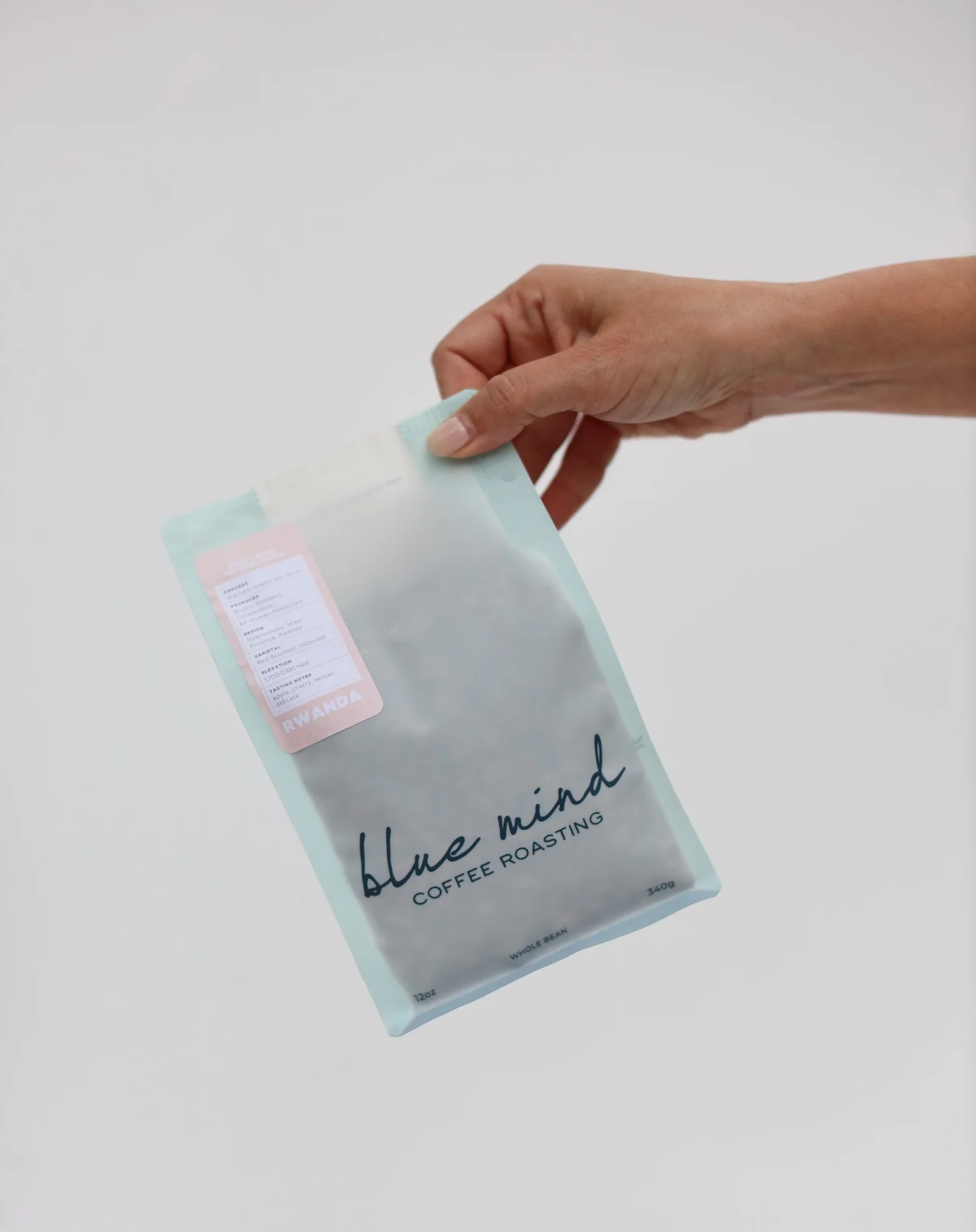A white bag of coffee beans from Rosso Coffee Roasters