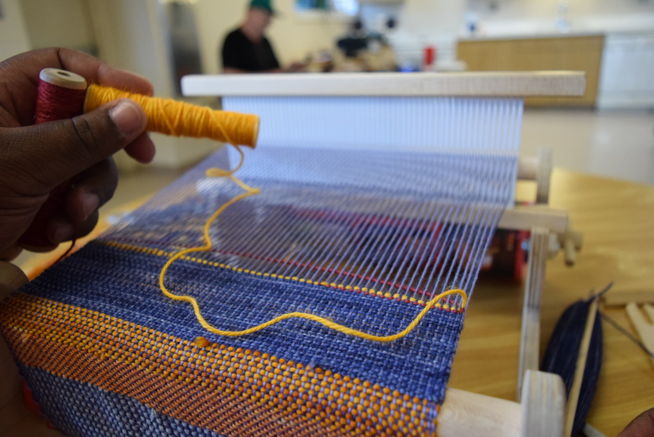Weaving workshop participant Robert Davis weaving with Alpaca wefts and bamboo floss warps at the Harrison Apartments in Bridgeport, CT.