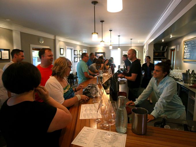 Carly O'Connell, right, talks with customers in the Argyle Winery tasting room in Dundee, Ore. (Photo: Ashley Smith, Statesman Journal)