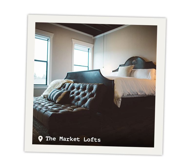 Interior view of the Market Lofts bed with a bench.