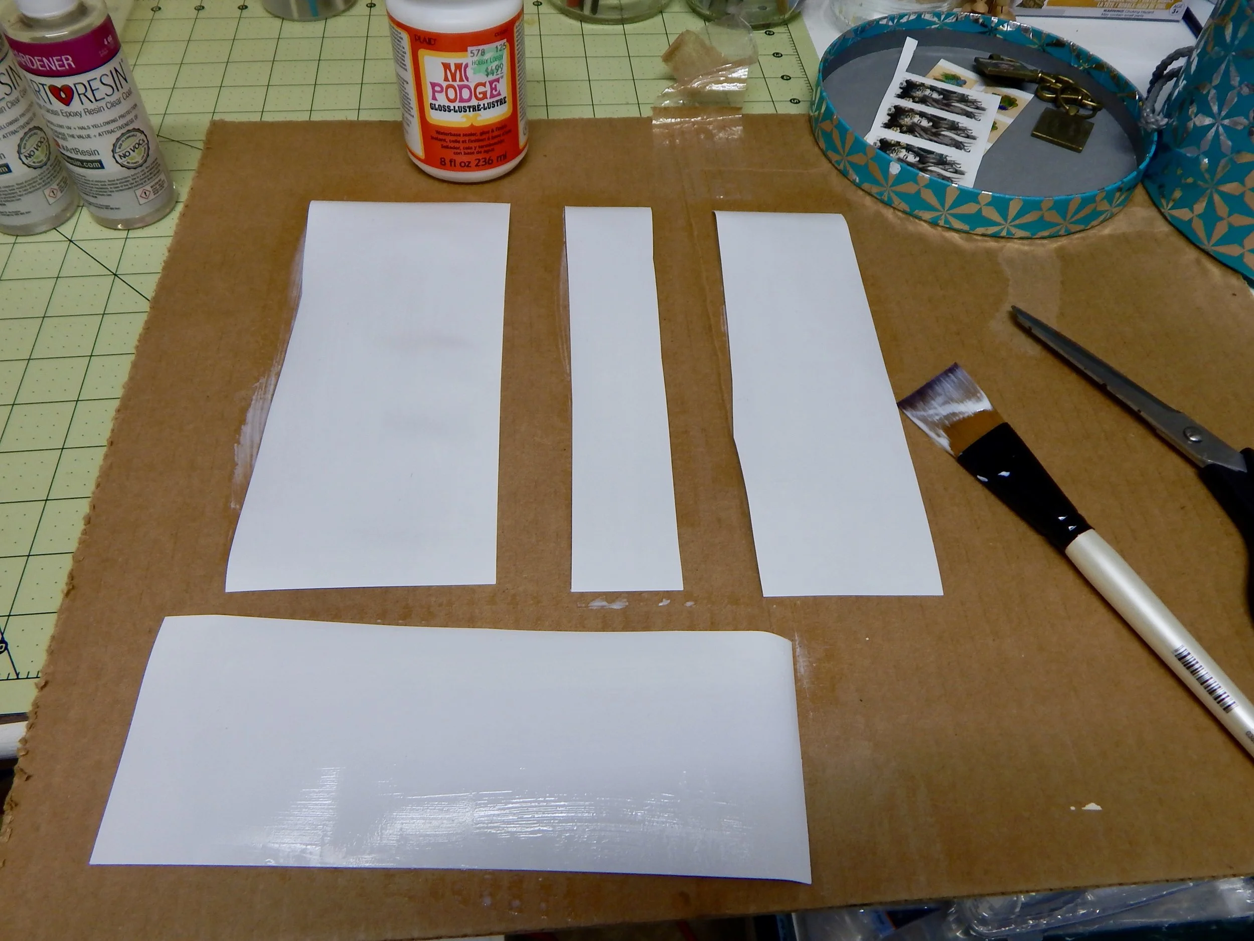 It may be easier to coat the back after you've cut the paper in to manageable strips. Do whatever works best for you!