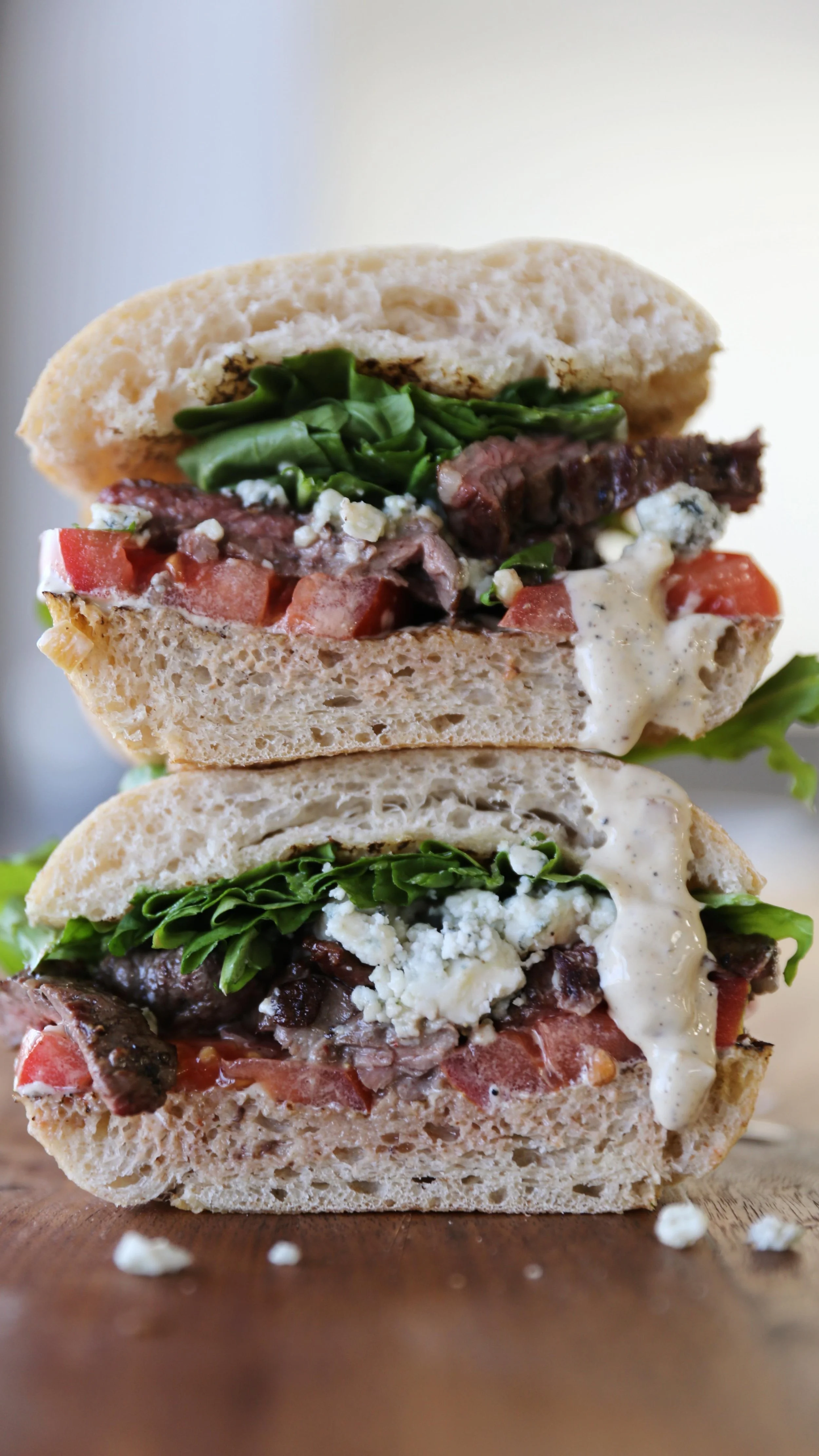 This is a high steaks sandwich!!! Say hello to our WORTH TAKEAWAY WEEKLY FEATURE, The Peppercorn Steak Sandwich! Slices of grilled skirt steak from @capital.farms , bleu cheese crumbles, peppercorn mayo, roma tomatoes and dressed arugula on toasted @