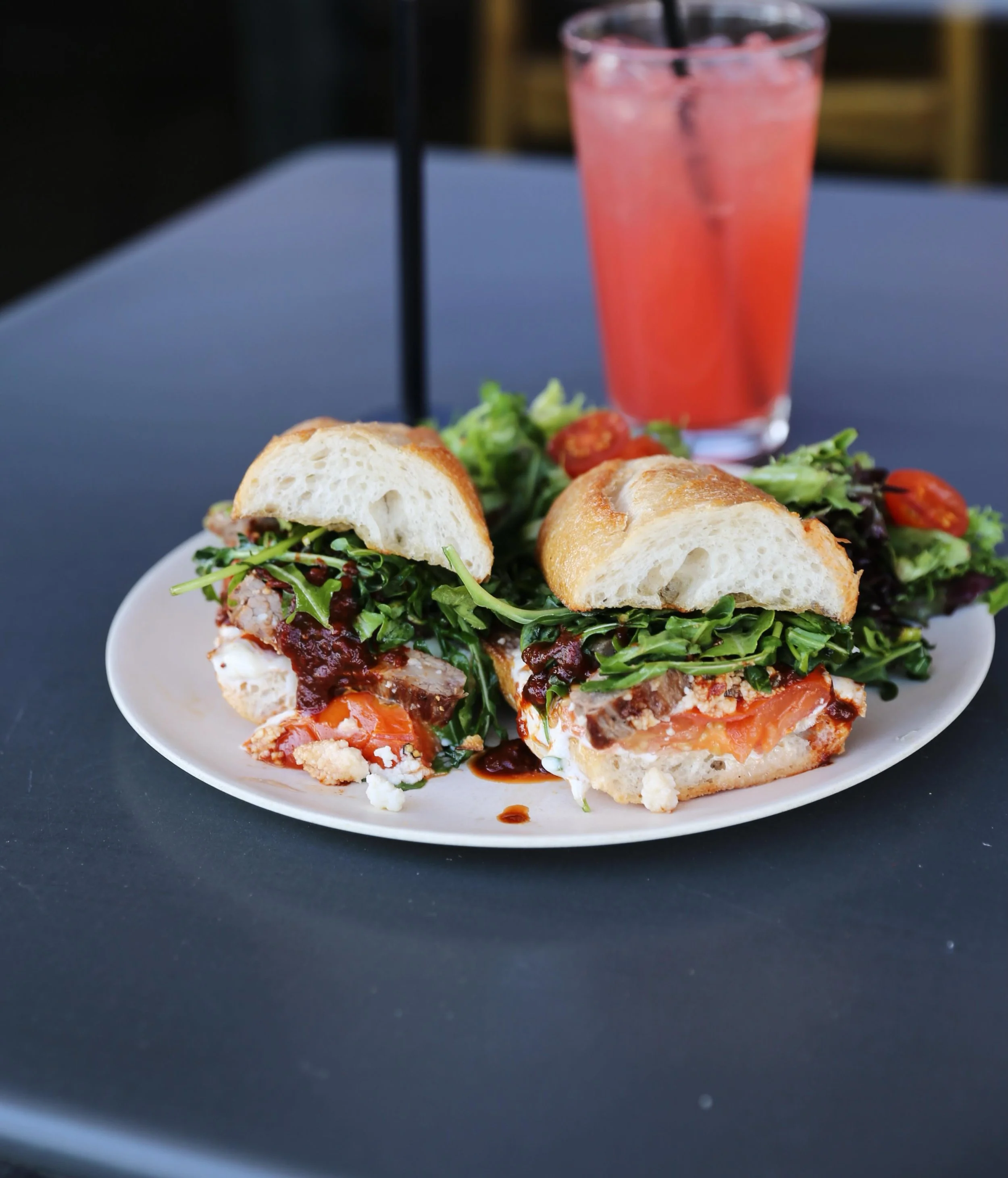 Steak my breath away!! Our WORTH TAKEAWAY WEEKLY FEATURE is the Chipotle Steak Sandwich! Seared tri-tip steak, arugula dressed with olive oil and lemon, chipotle chili sauce, oven roasted tomatoes, queso fresco, and mayo on a @noblebread baguette.

S