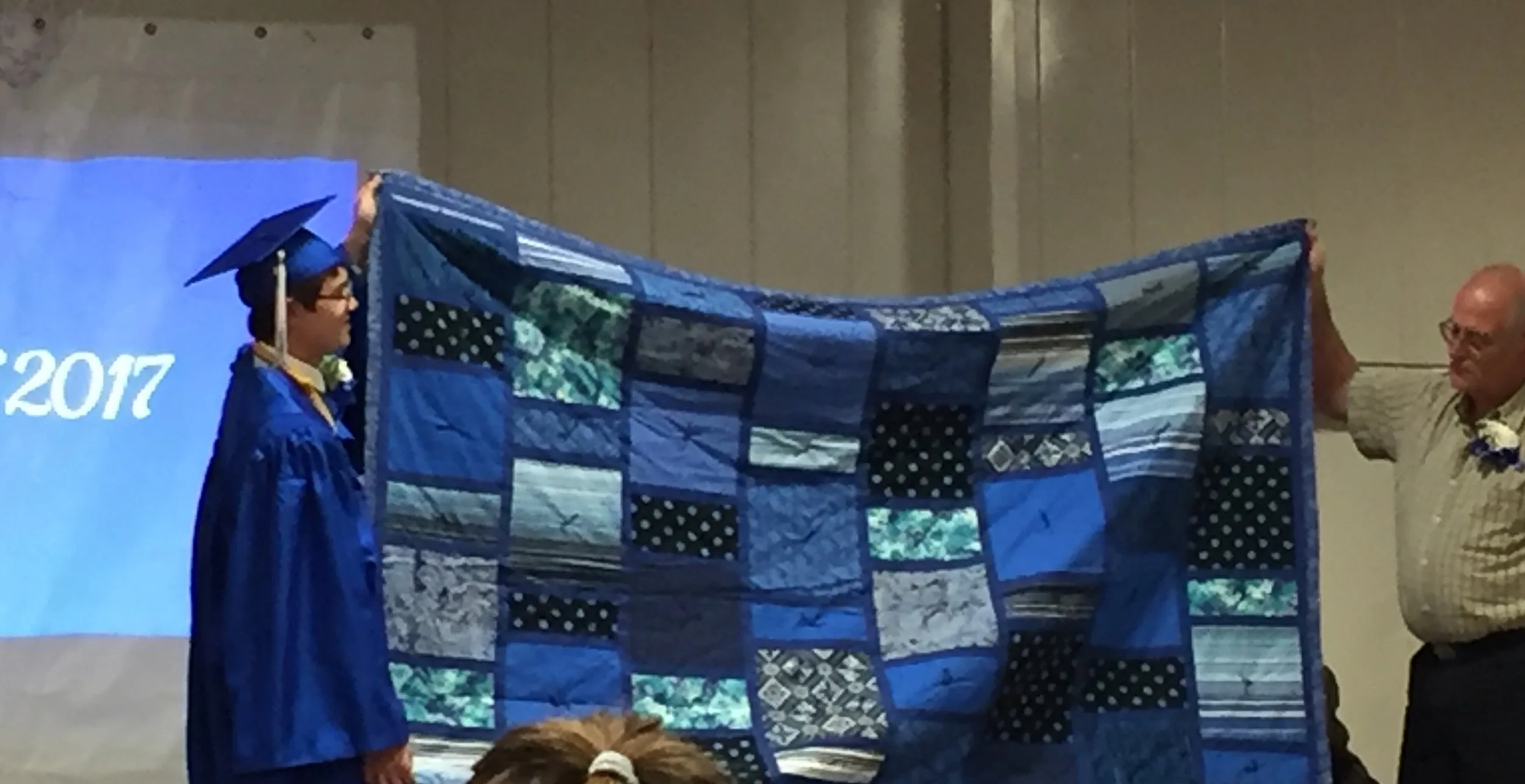 Chris with his quilt. He will be attending college in Shanghai in the Fall so the thought was that all of the shades of blue would remind him of the waters around the Island.