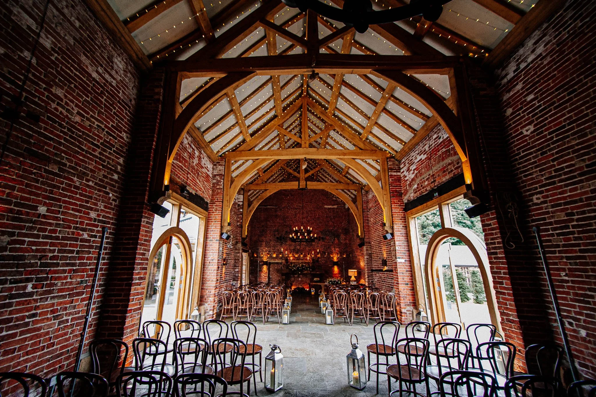 Hazel Gap Barn wedding venue in Nottinghamshire with red-brick arches, wooden beams and rustic barn interior