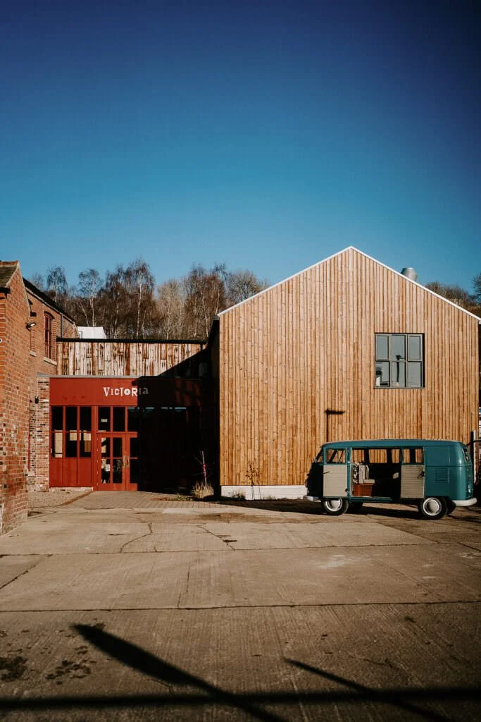 Victoria Hall in Sheffield with its wooden exterior and red entrance doors.