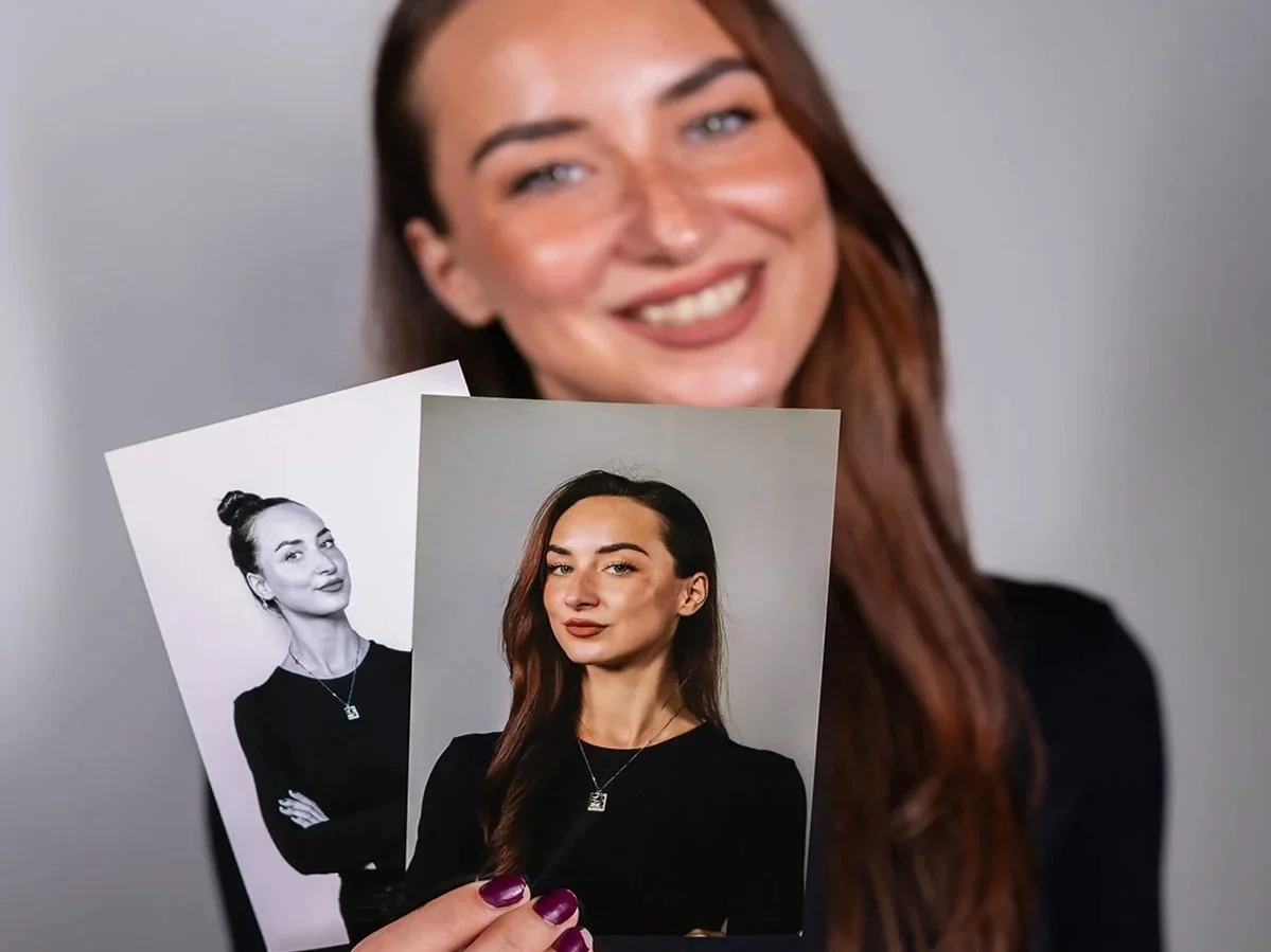Guests holding printed professional headshots captured at a corporate event