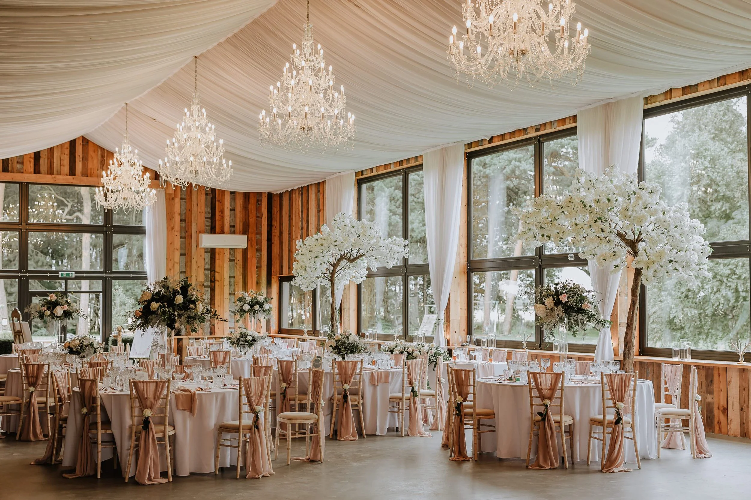 Bunny Hill Weddings barn venue with elegant draped ceiling, chandeliers and modern wedding reception décor.