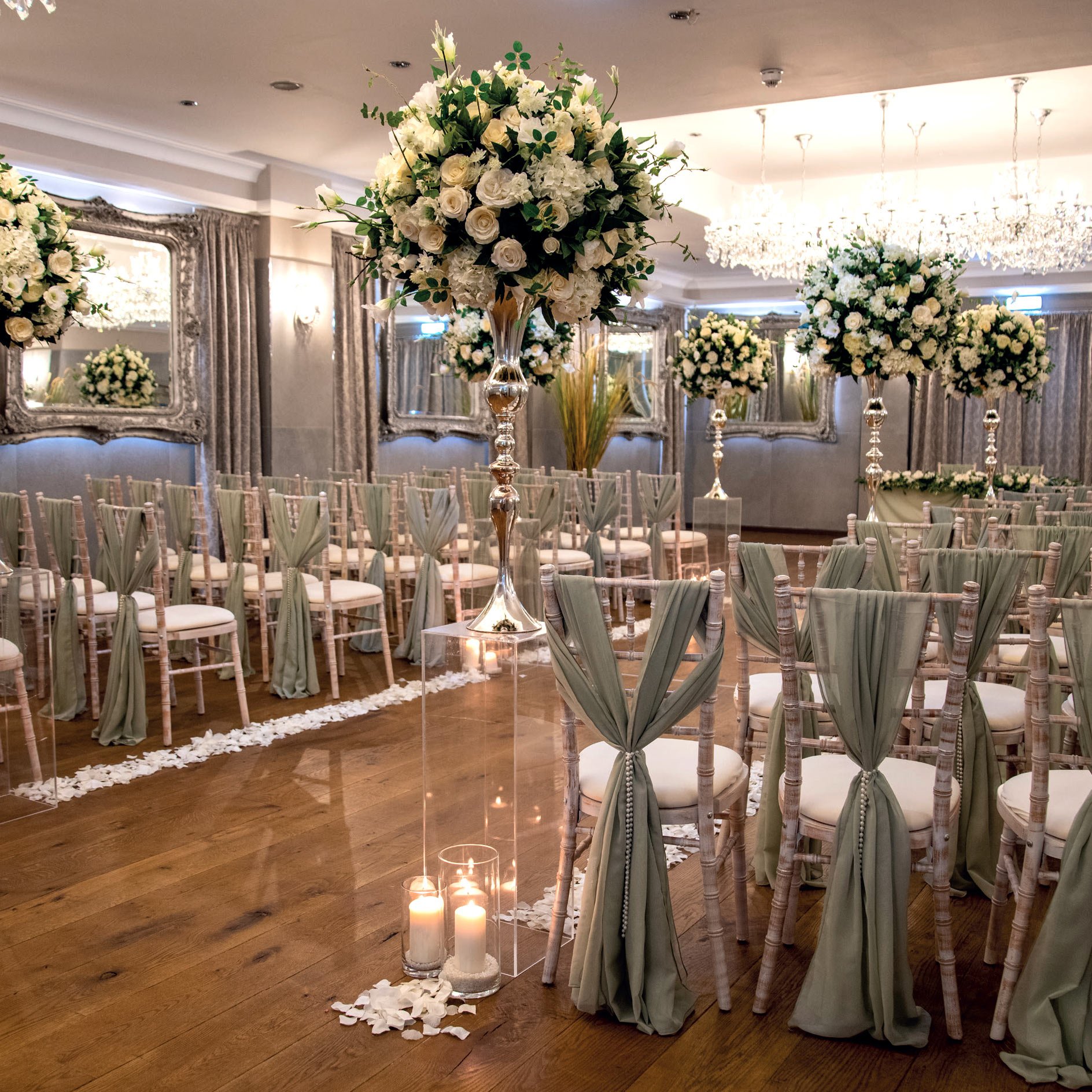 Wedding ceremony setup inside The Crown Hotel, Bawtry with floral centrepieces and elegant chairs.