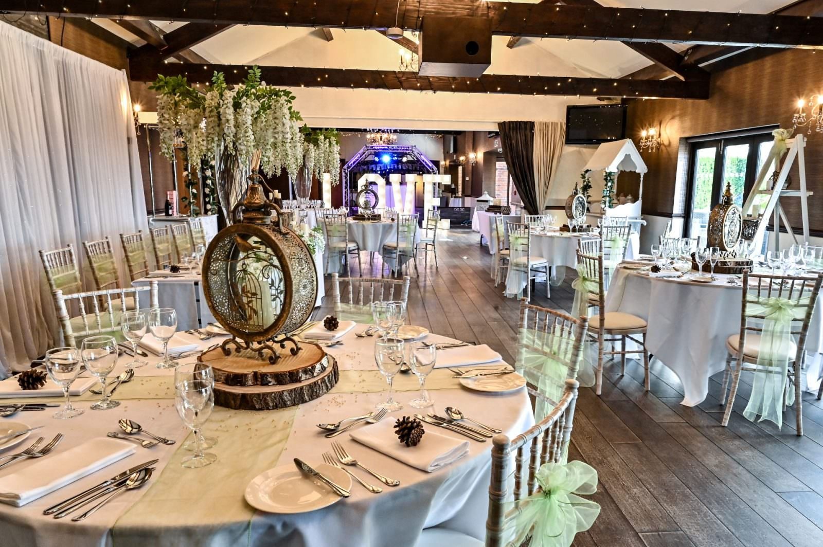 Goosedale wedding venue in Nottingham with decorated reception tables and rustic wooden beams.