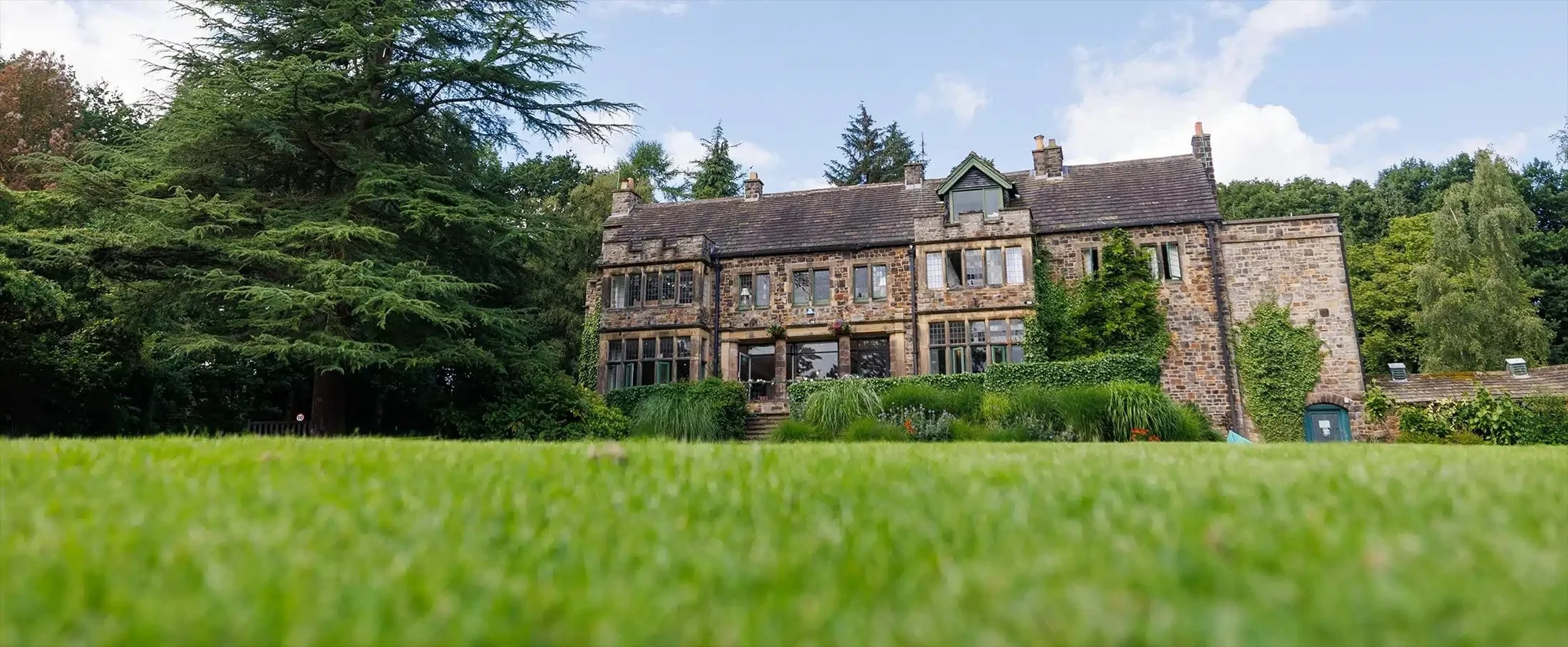 Whirlow Brook Hall wedding venue in Sheffield with its stone exterior and surrounding gardens