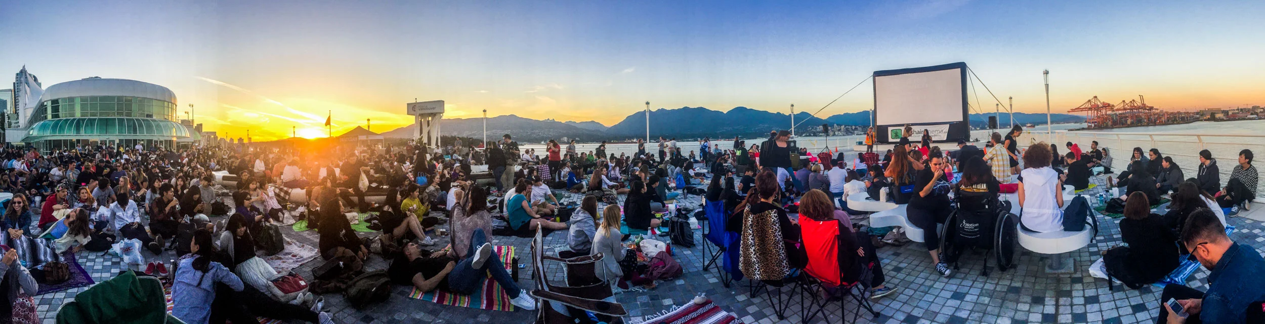 Sunset at Canada Place's North Point where a crowd gathers to watch a waterfront movie in Vancouver.