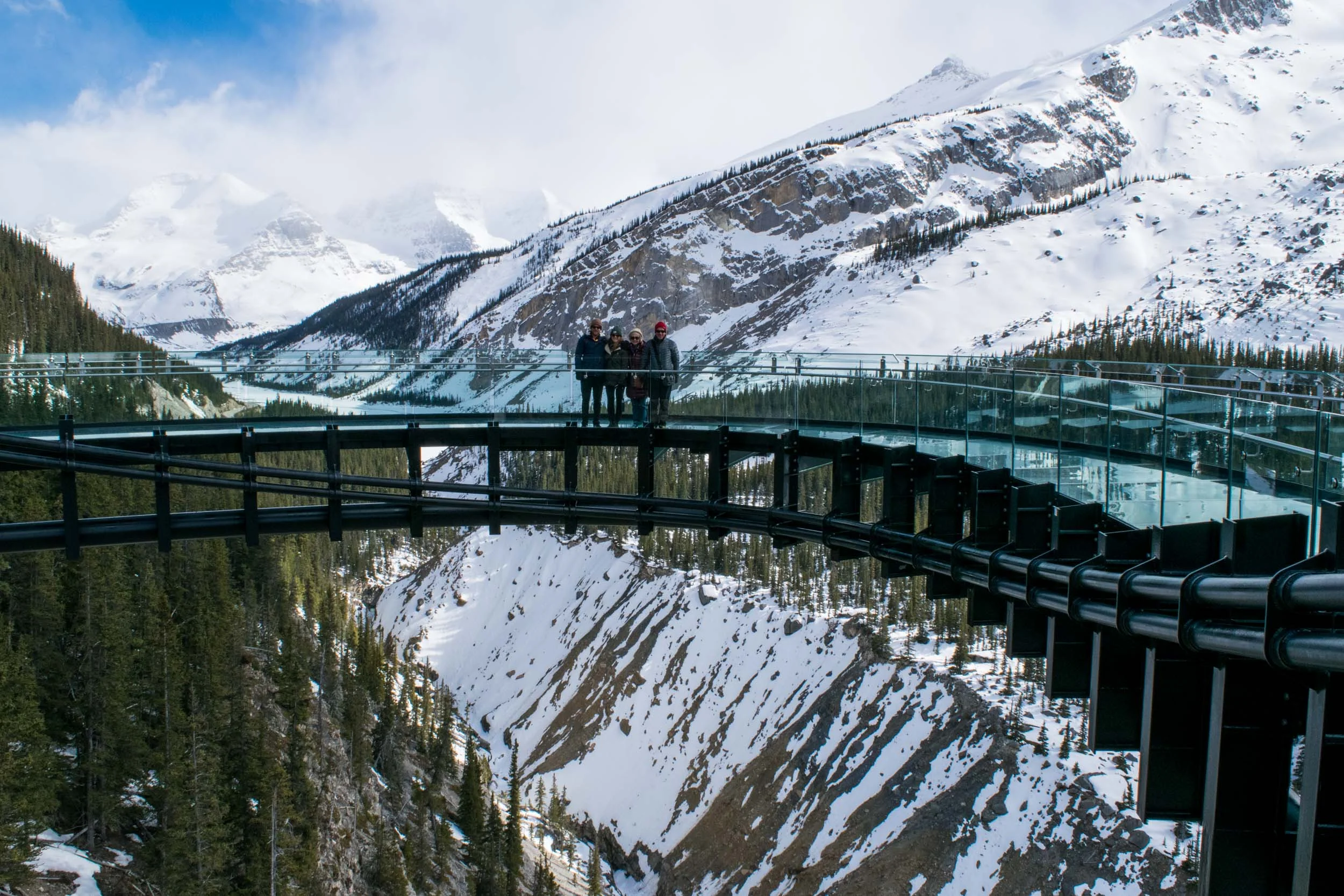 Family stood on the Glacier Skywalk at the Columbia Icefields in Alerbta, Canada.