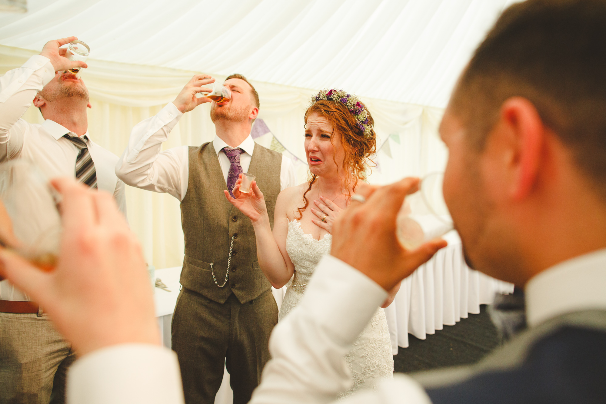 bride drinking shots, reportage wedding photo