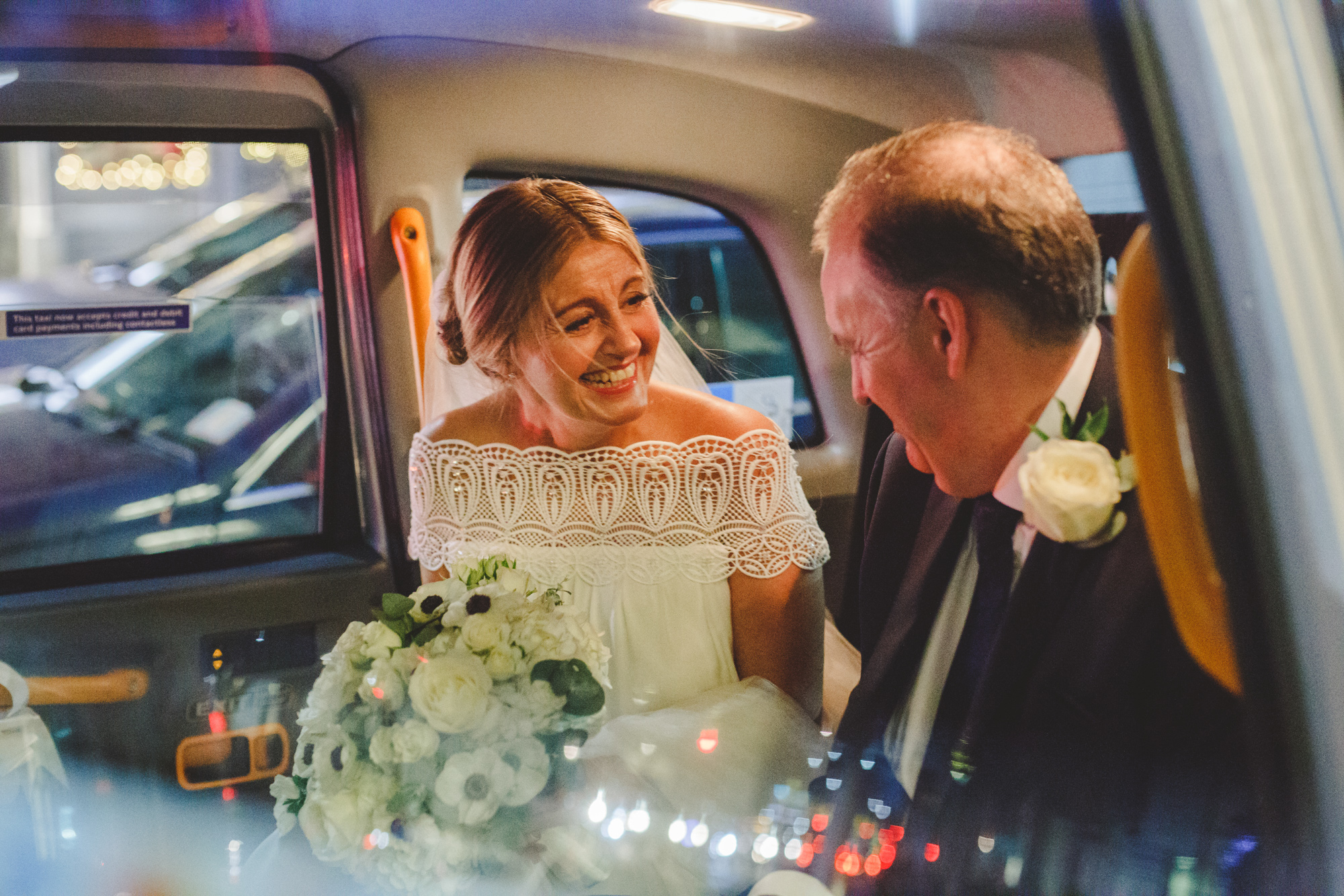 london wedding photographer, bride in wedding taxi with vintage dress