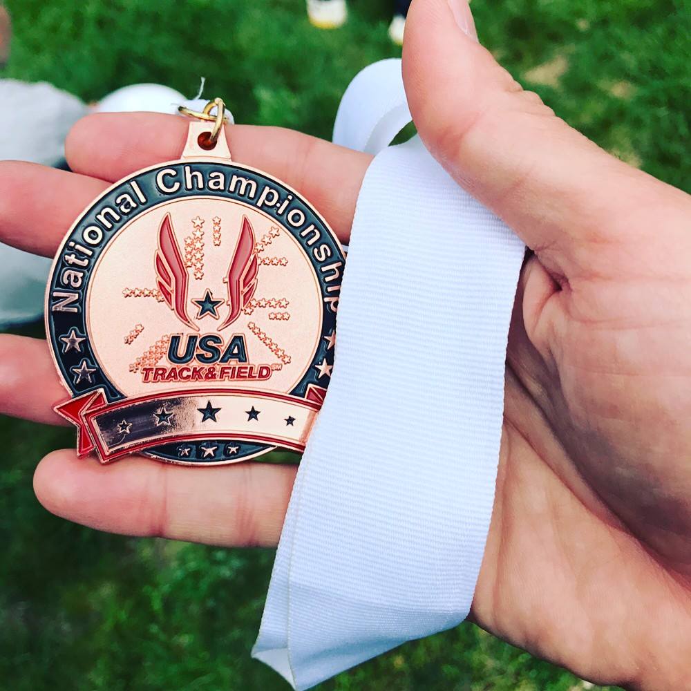 Frankie Adkins collecting USATF hardware 
