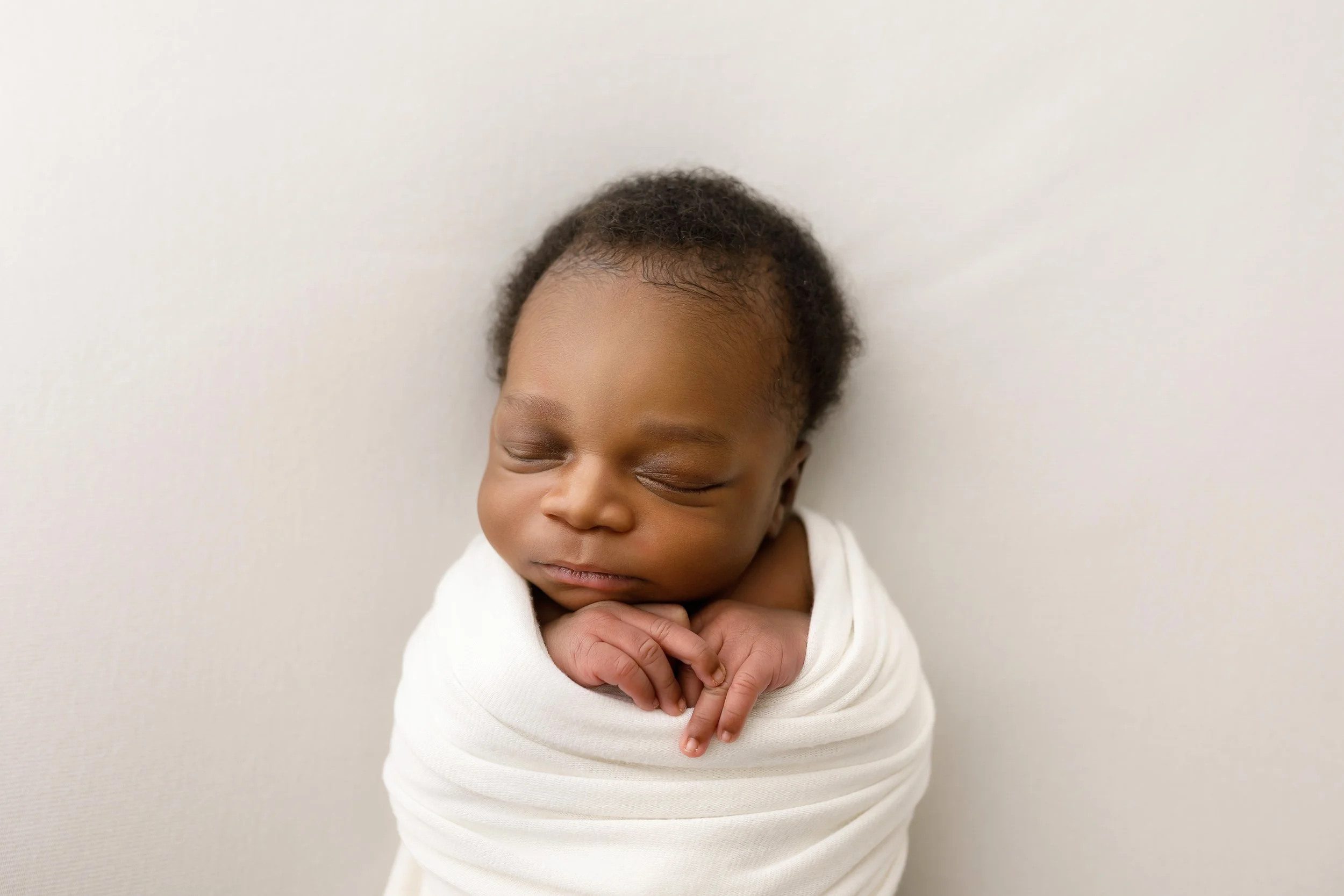 Newborn baby wrapped in neutral tones at Atlanta photography studio.jpg