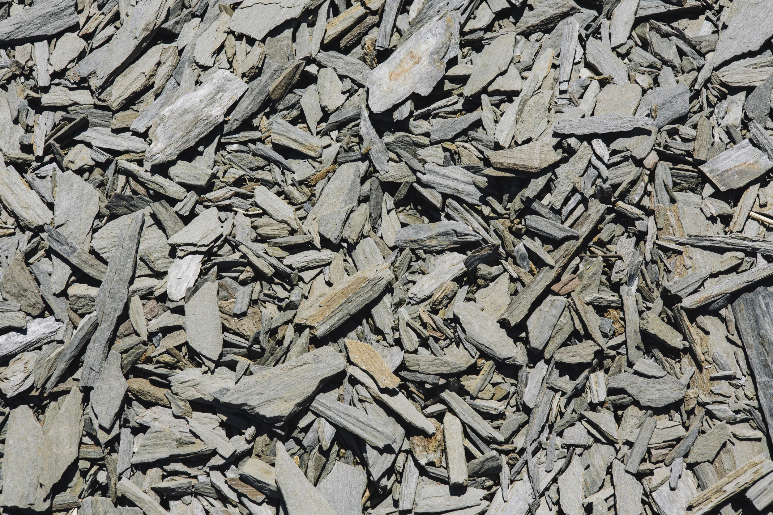 Close-up of gray and beige irregularly shaped small rocks or gravel.