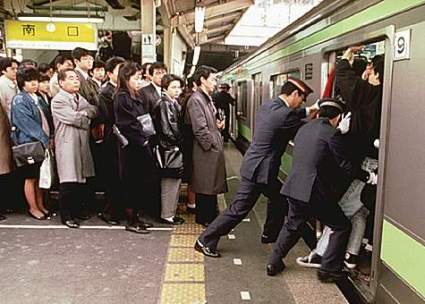 People being pushed into a crowded train in Tokyo