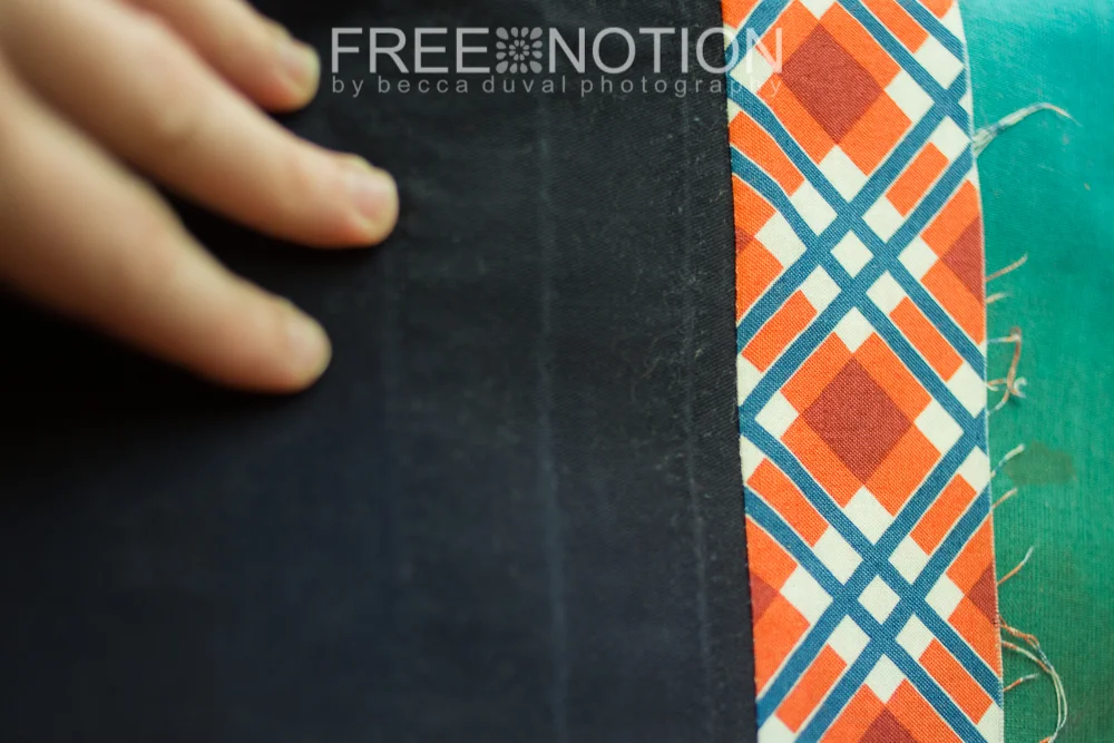 Of the 3 creases Left of the facing seam, the one under my finger is the original hem stitching, the one in the middle is the original hem length, and the on 1/4 from the facing seam is where the raw edge had been turned under and enclosed in the hem.