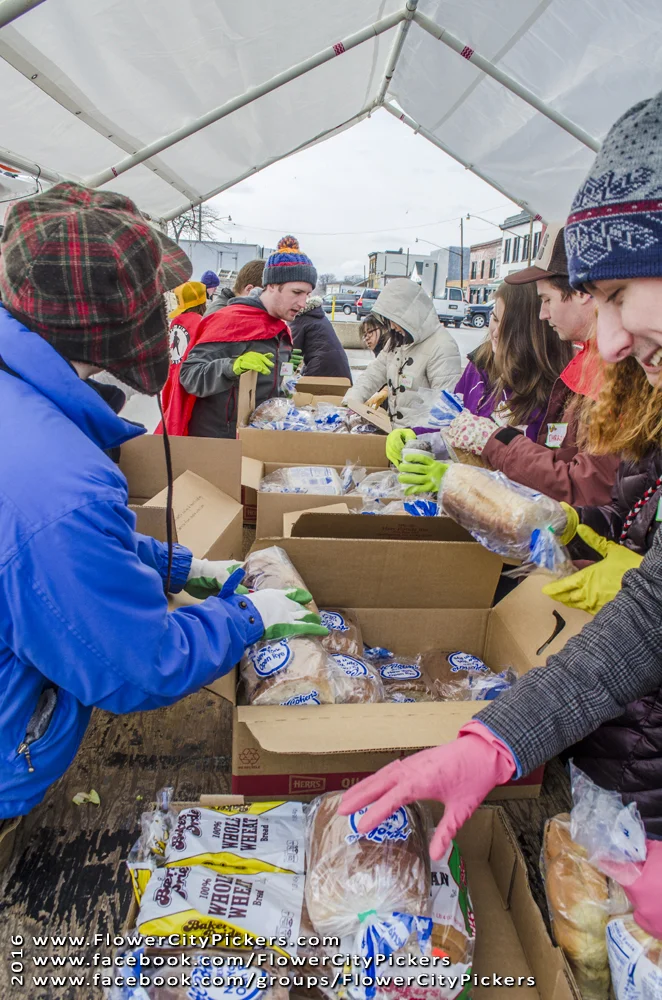 Flower City Pickers volunteers sort through packaged goods. Photo provided by FCP.