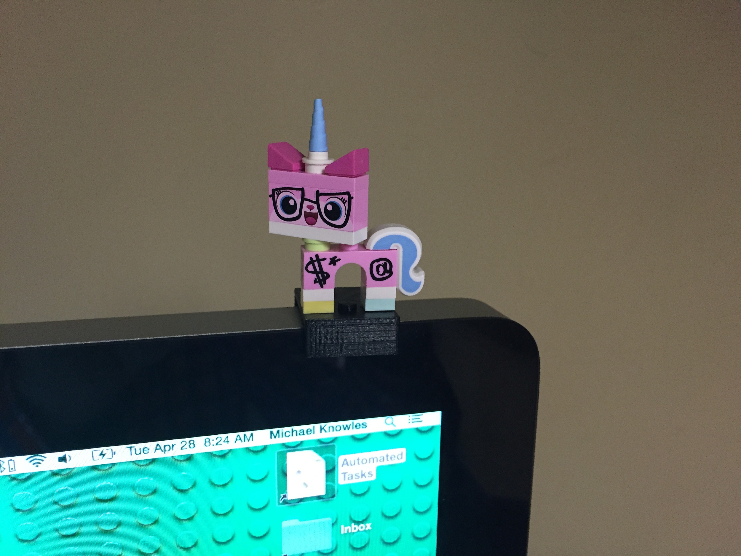 Biznis Kitty hanging out on my monitor.