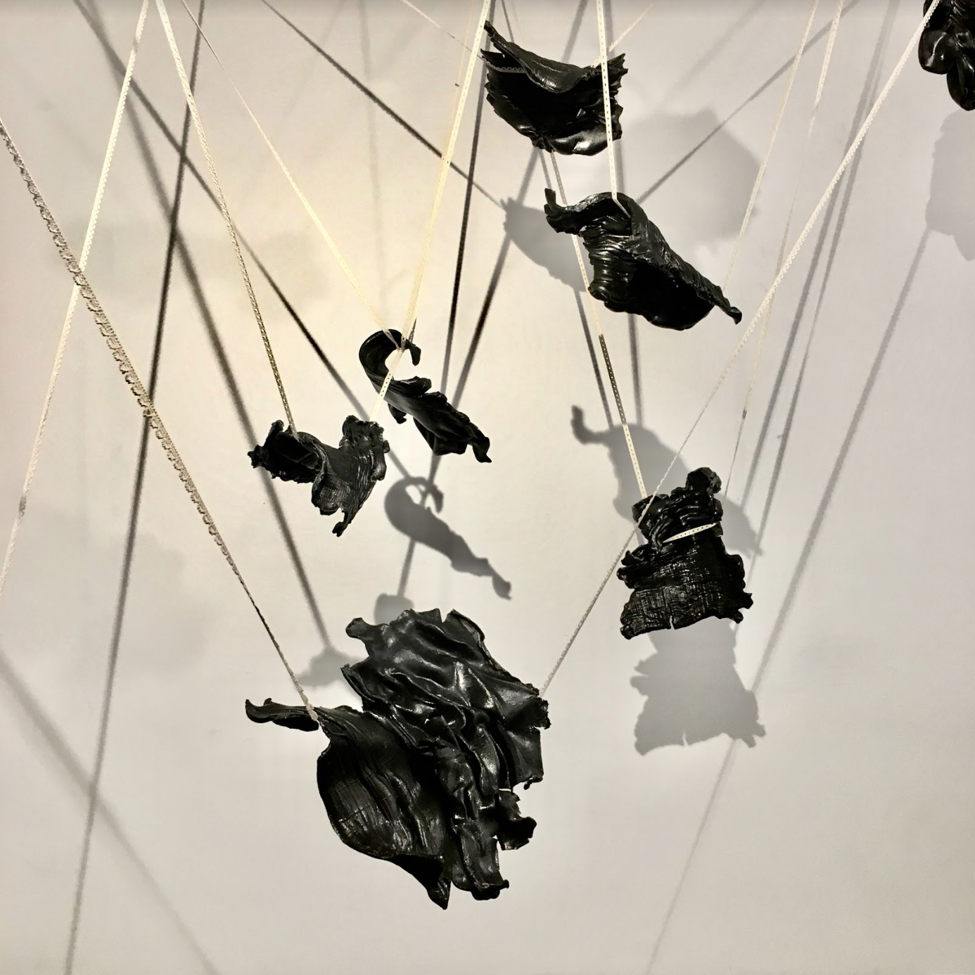Trajectory. Stoneware, black terra sigillata, lace. Installation approx. 12'L x 7'W x 9'H