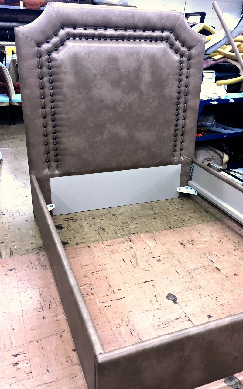 Bed upholstered in engineered leather and with decorative nail