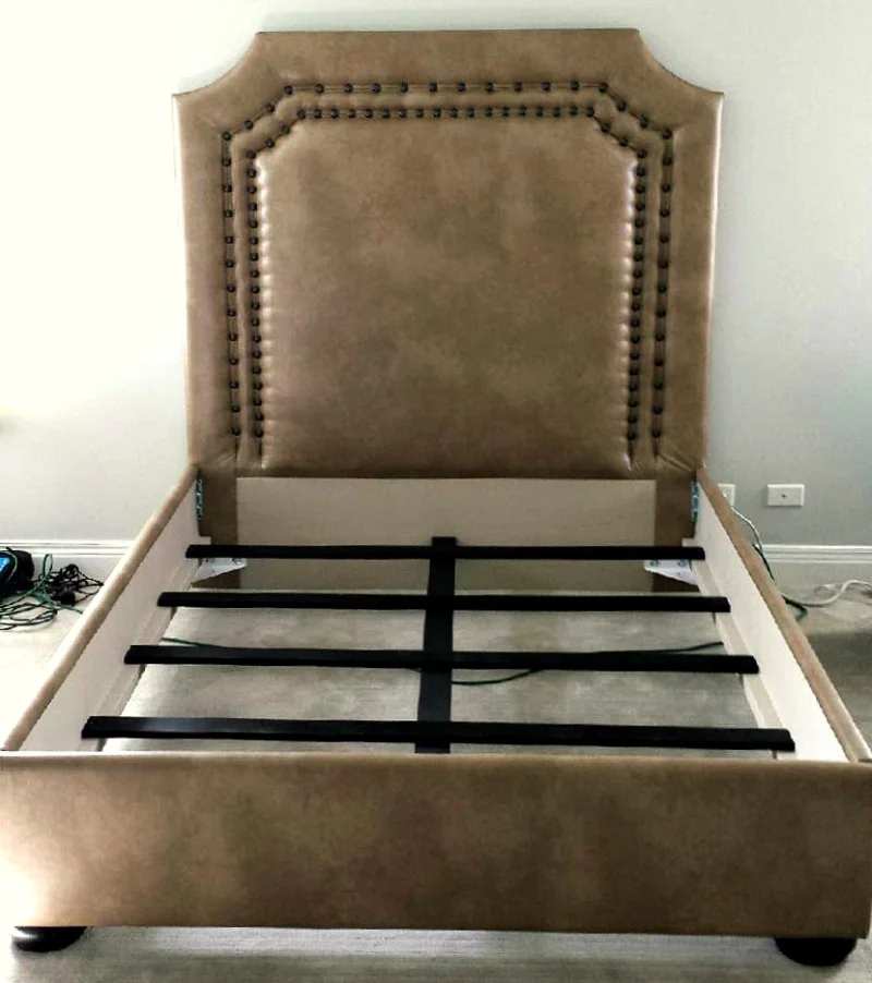 Bed upholstered in engineered leather and with decorative nail