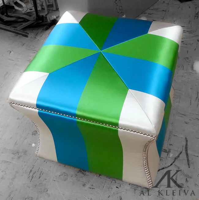 Curved side custom ottoman with nickel finish