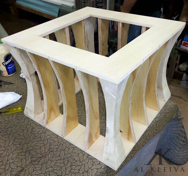 Curved side custom ottoman with nickel finish