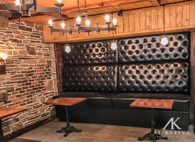 Bar height booth with tufted wall panels