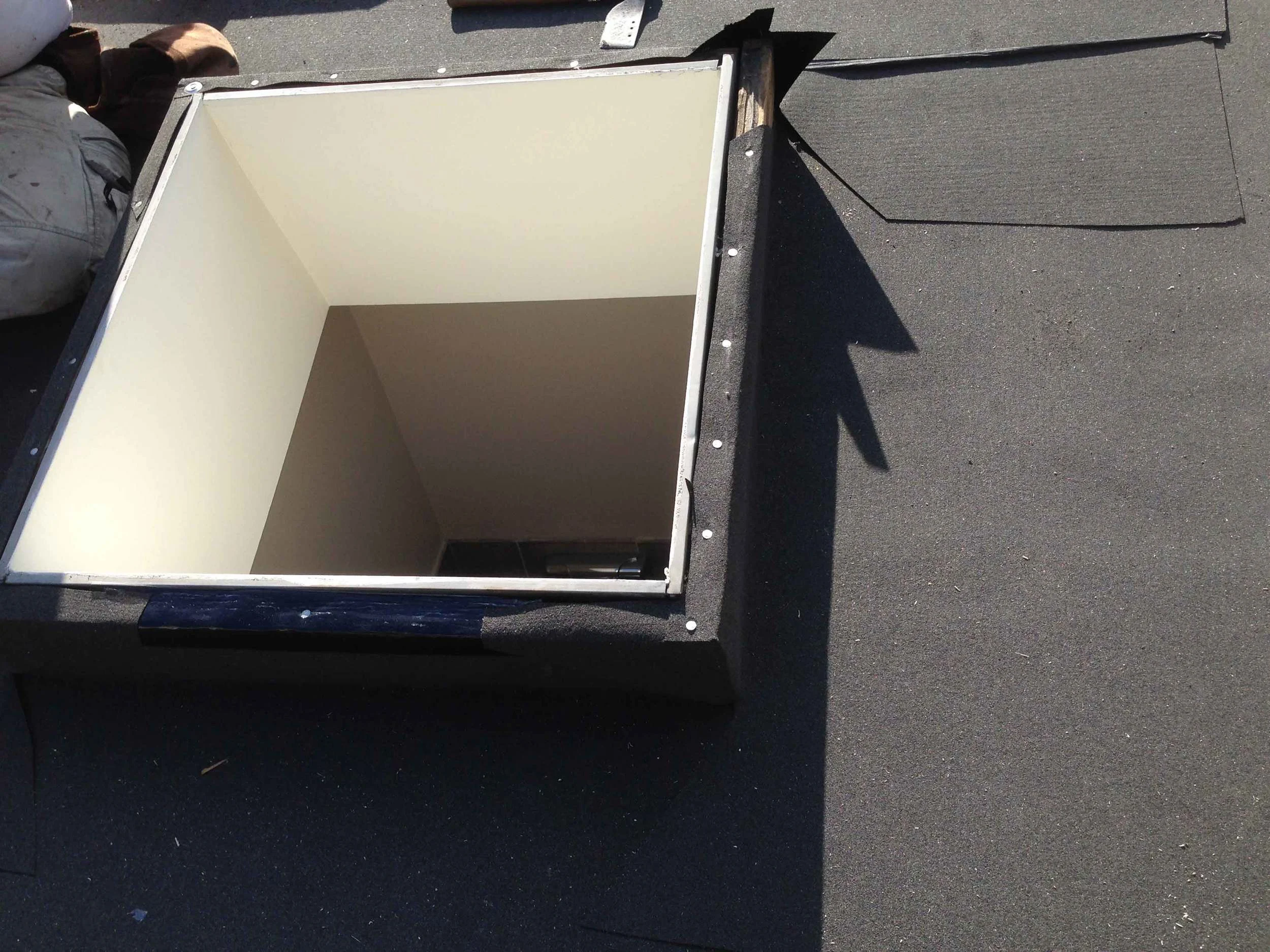 A rubber membrane goes around the skylight frames before any other roofing. The whole roof is covered in this as well (not shown).