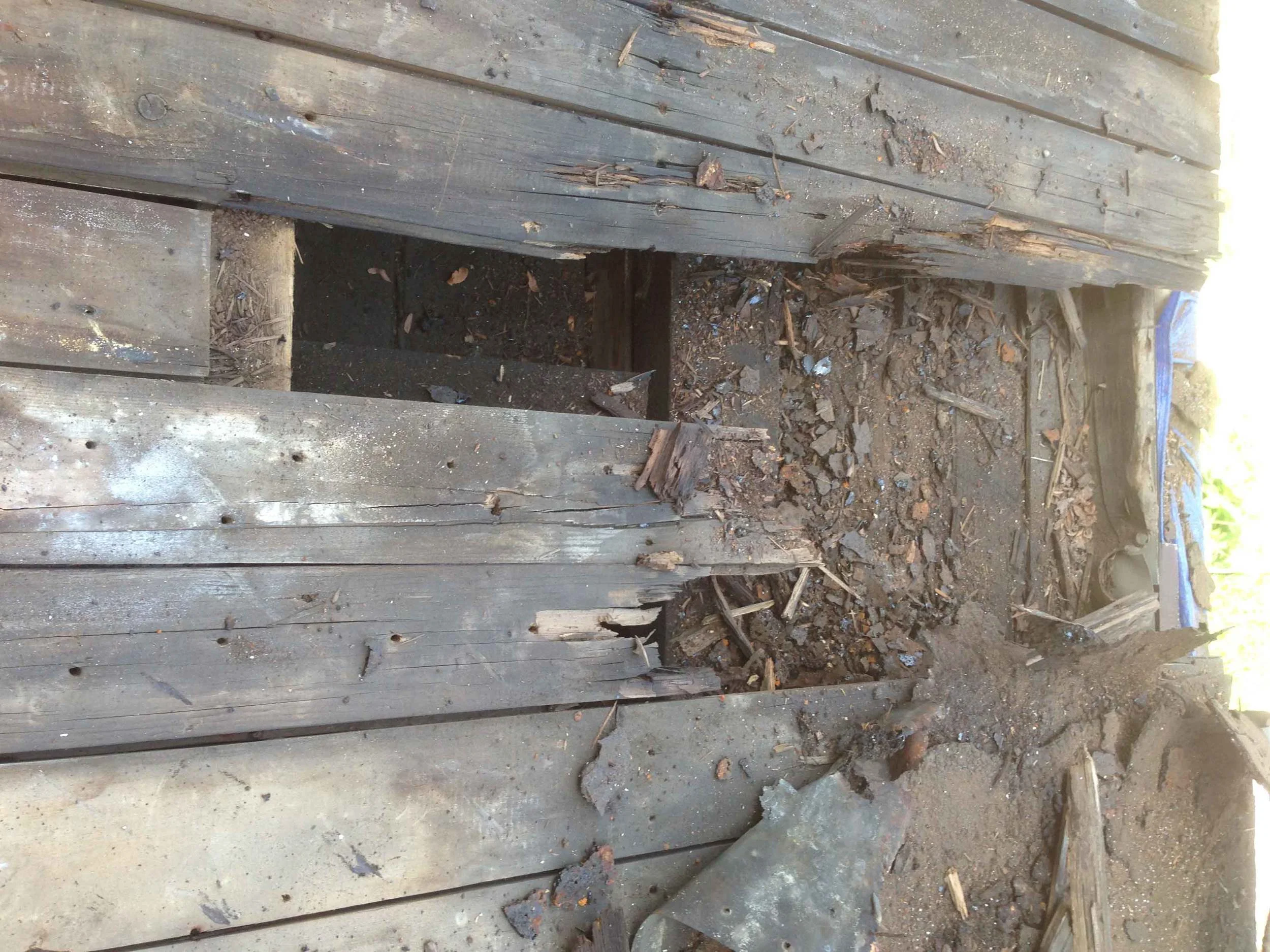 Lots of wood rot on front porch flat roof: also wood behind eaves trough is rotted out